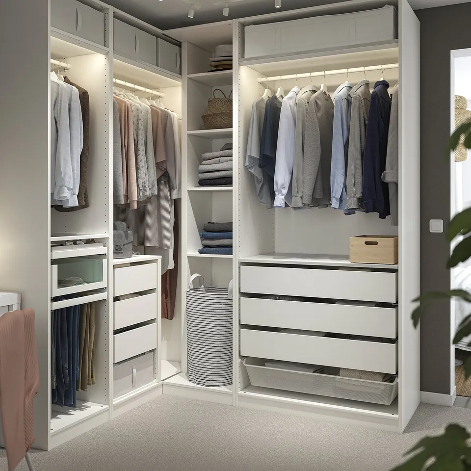 Large PAX walk-in closet with shelves, drawers, and lighting for a modern, minimalist look.