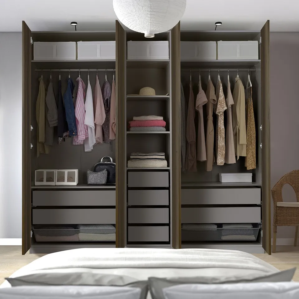 Bedroom closet, PAX wardrobe with open doors showing clothes, drawers, and storage compartments.