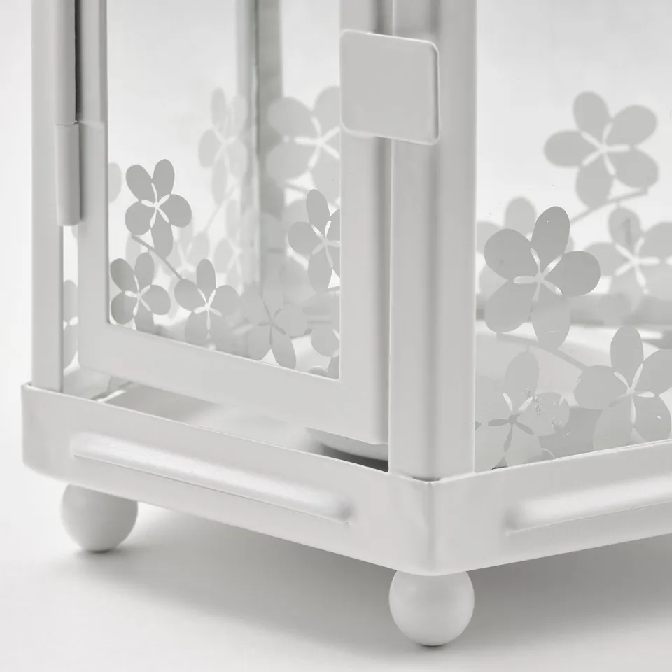 White metal lantern detail, floral cutouts, steady round feet.