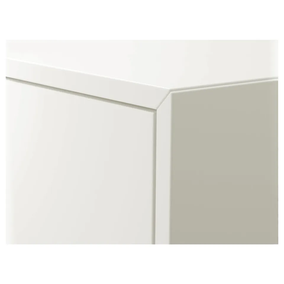 Modern, white, wall-mounted storage cabinet with sleek edges.