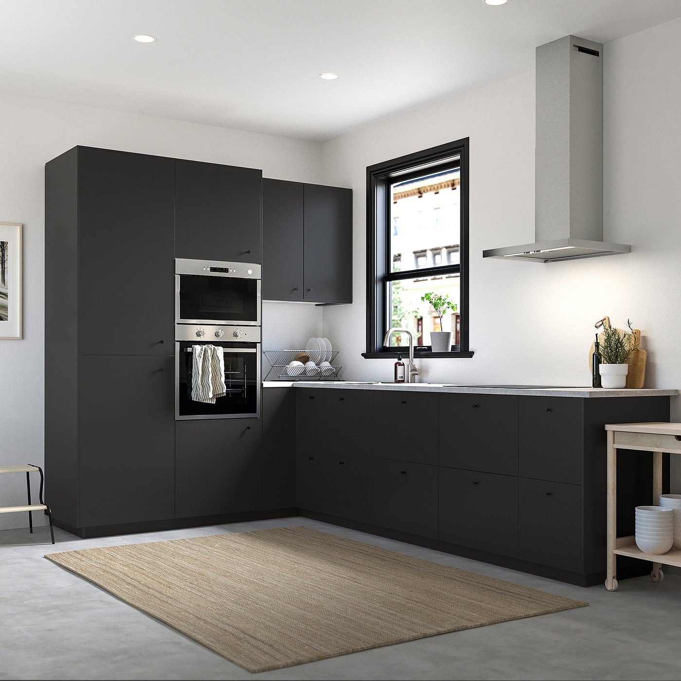 Modern kitchen with NICKEBO black cabinets, stainless steel oven, and chrome tap. Large window, botanicals, and a beige rug.