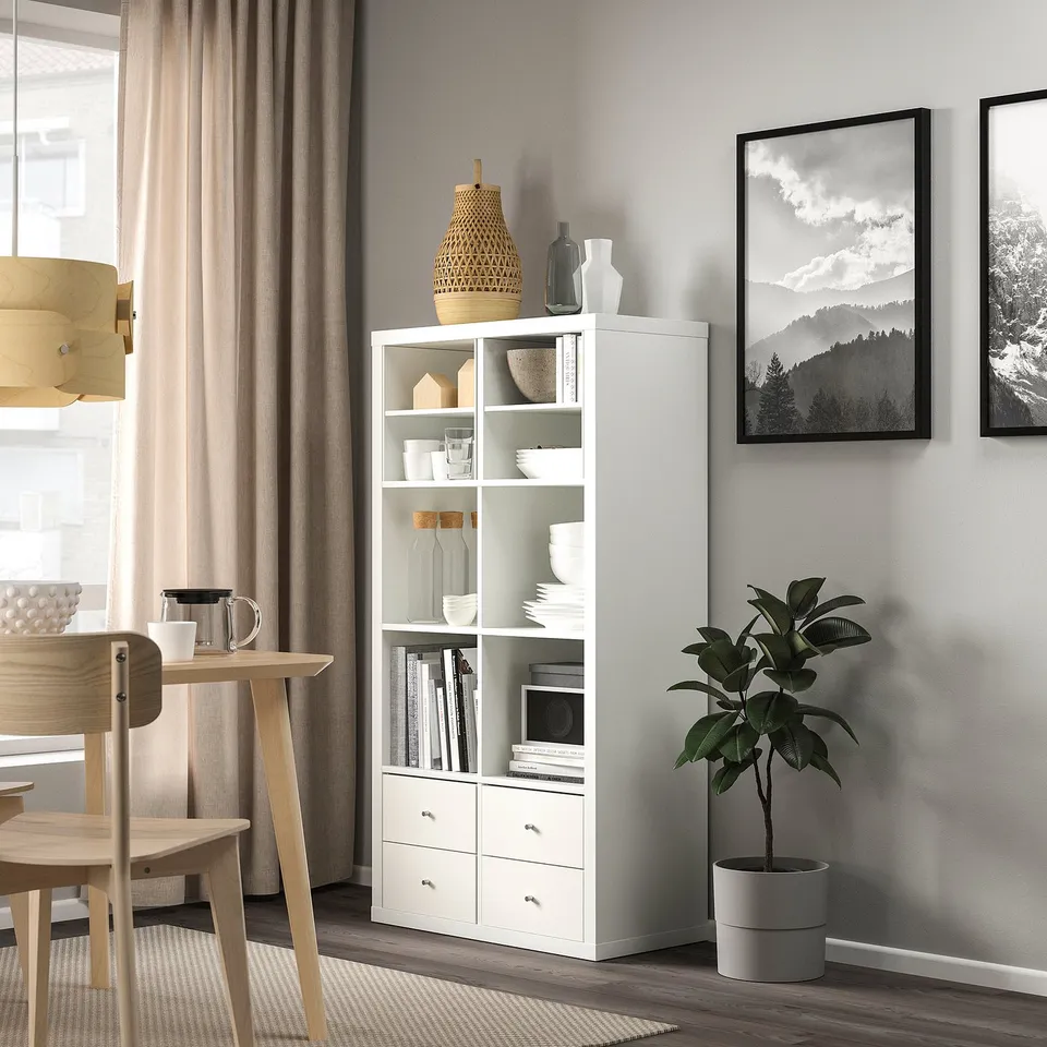 Modern living space with KALLAX shelf and wooden dining set with plant.