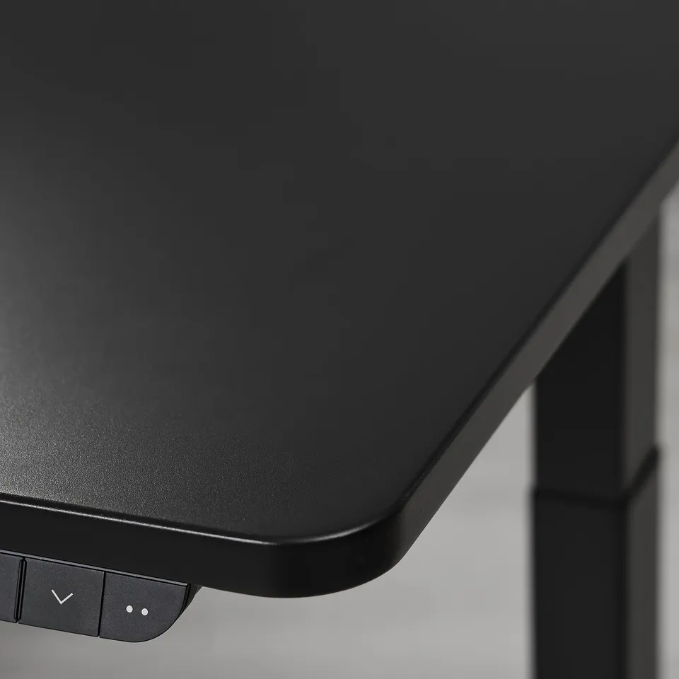 Close-up of high-quality, black adjustable gaming desks sleek, matte surface and control panel.