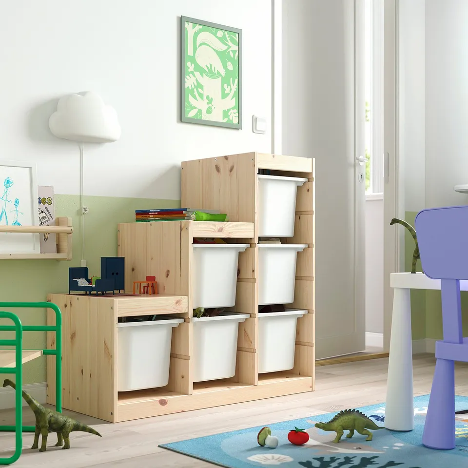 Kids room with TROFAST storage, dinosaur toys, colourful rug, pendant lamp, and artwork.