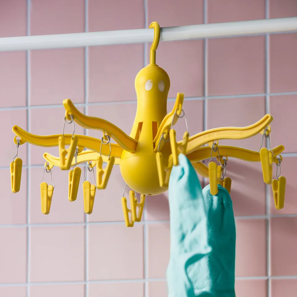 Yellow hanging dryer with 16 pegs holds small clothes, socks, underwear indoors/outdoors.