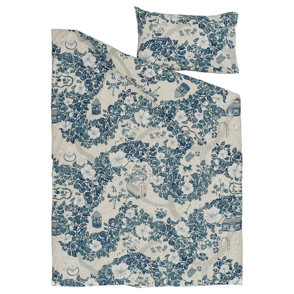 A blue "PJÄXE" duvet cover set with a floral design, laid flat. The material is 50% cotton, 50% lyocell.