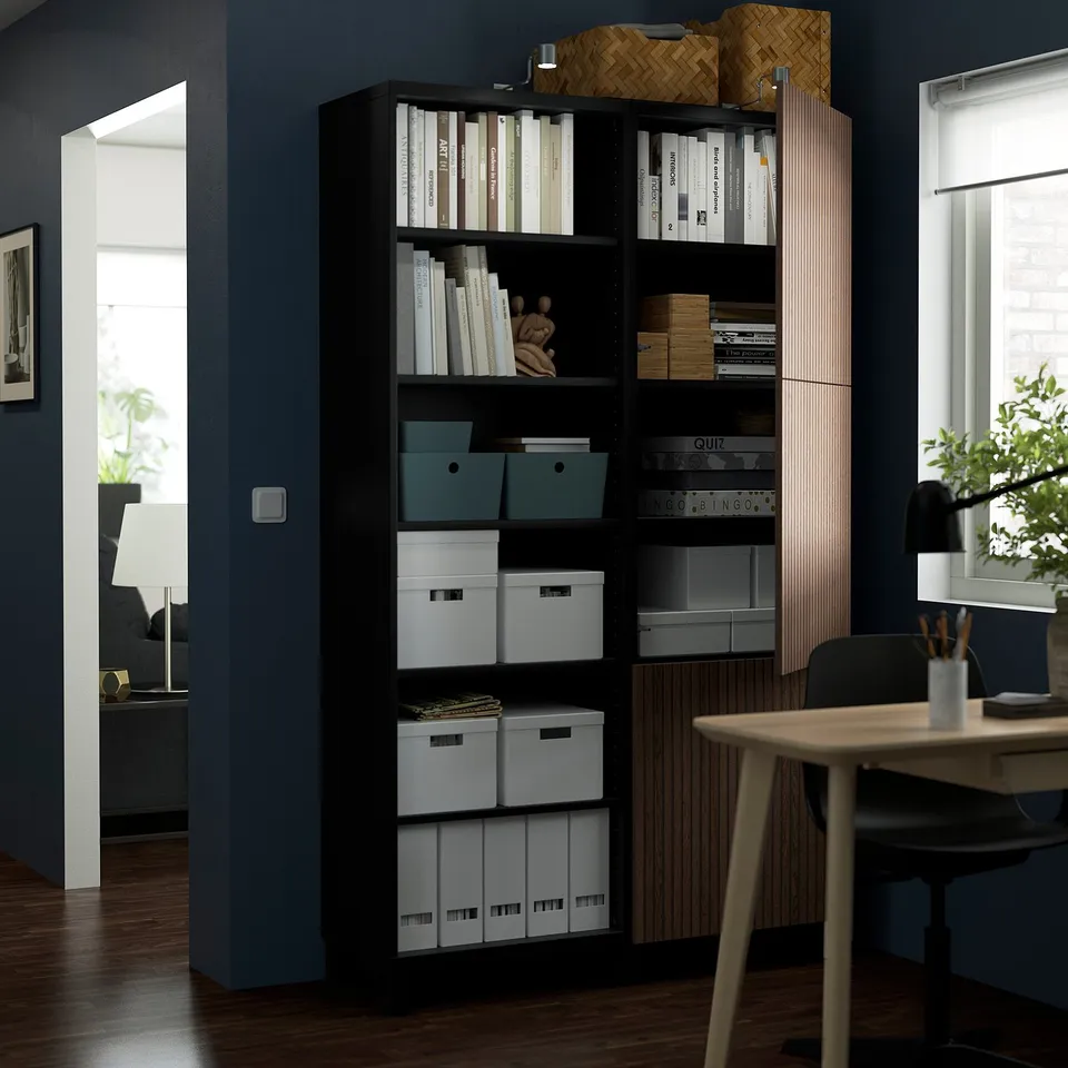Bookshelf with open and closed storage, showcasing items and hiding clutter. Shelves are adjustable, and the unit is wall-mounted.