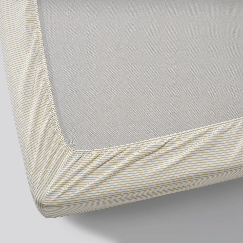 Image shows a neatly folded corner of a high-quality cotton fitted sheet with elastic edges, designed to fit thick mattresses.