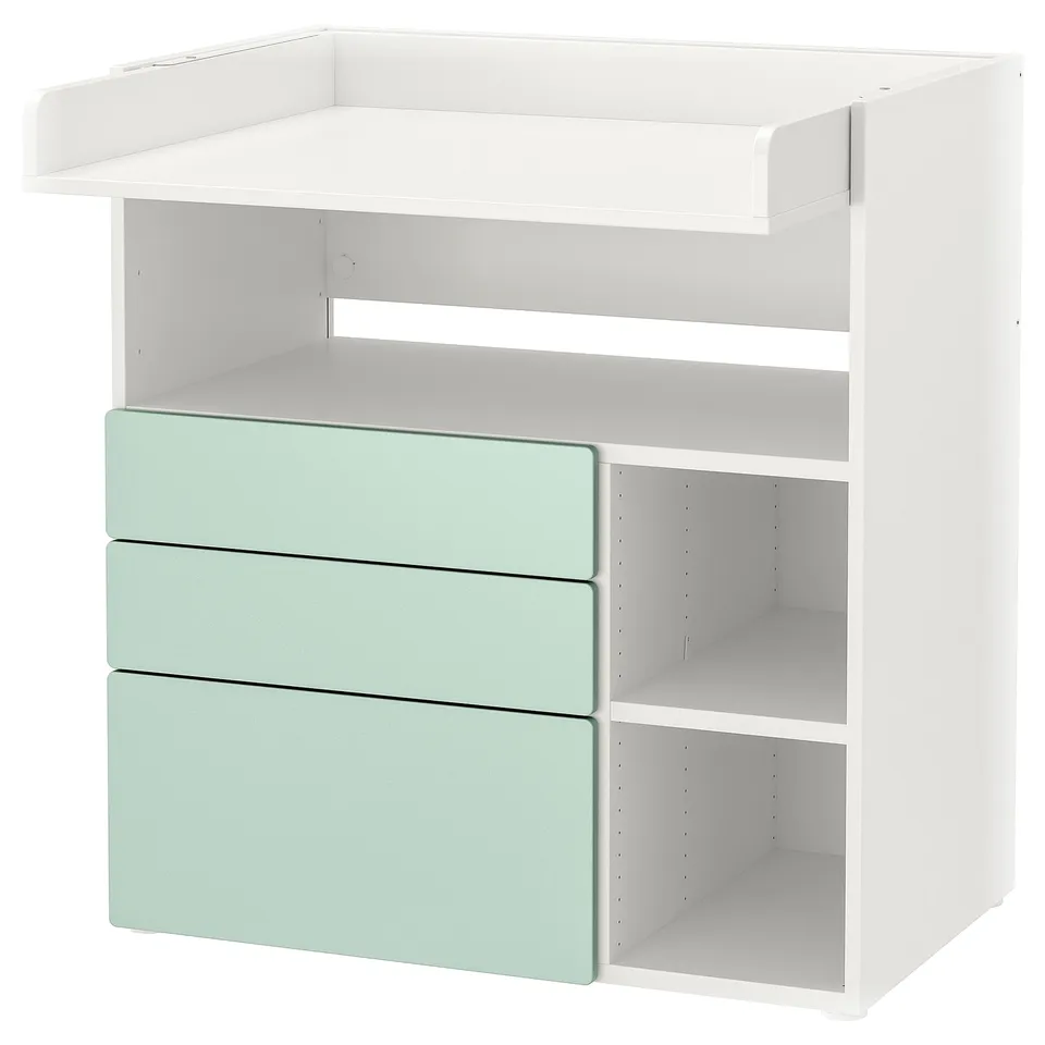 A white and green baby changing table with drawers and shelves for storage.