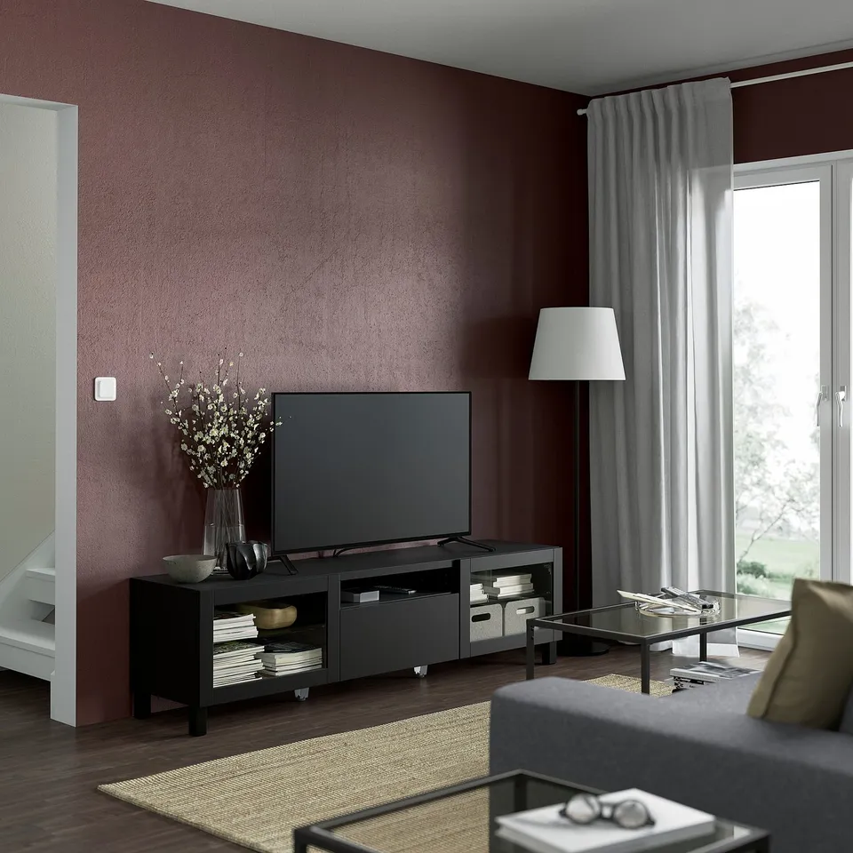 Modern living room with SINDVIK tv stand, vase, large window, coffee table, and grey sofa.