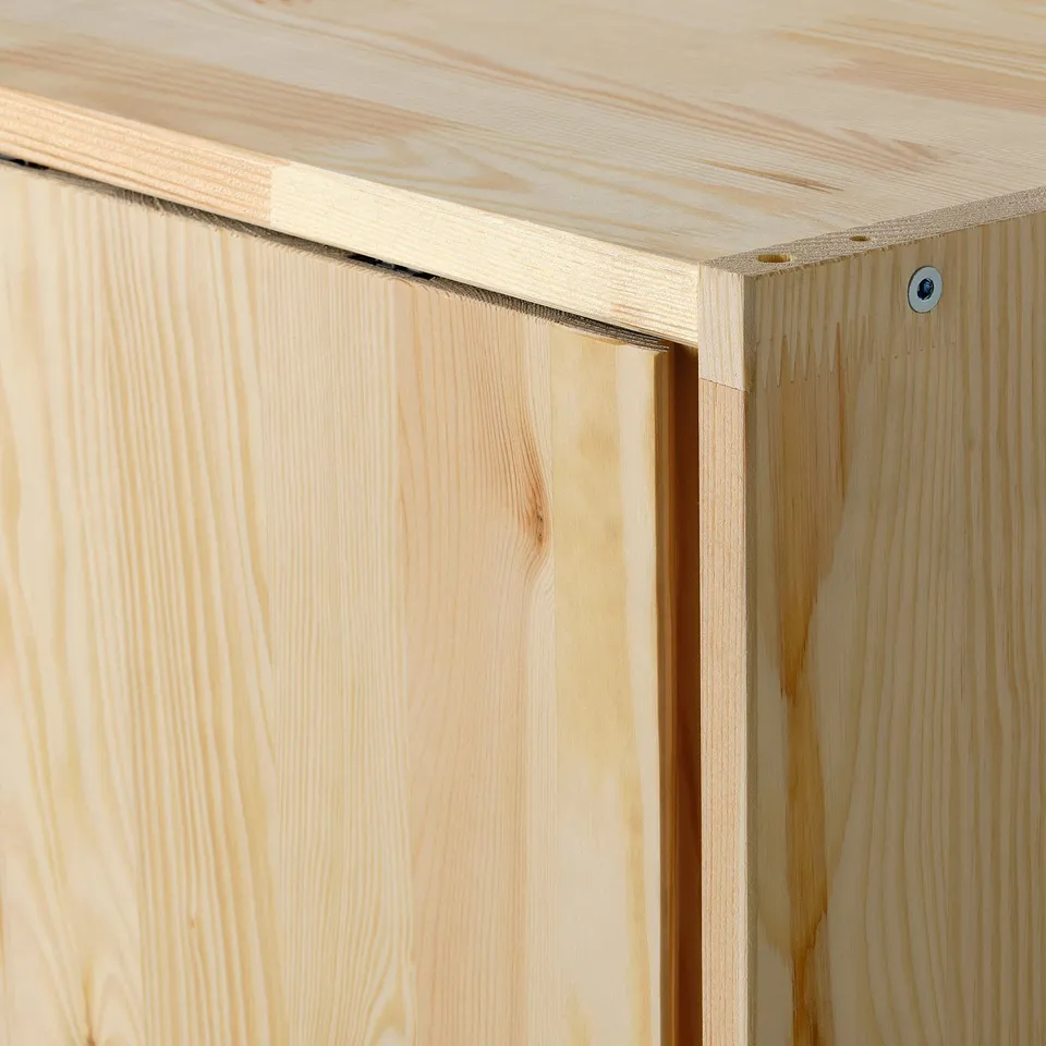Close-up of wooden furniture corner, showing natural grain and smooth finish.
