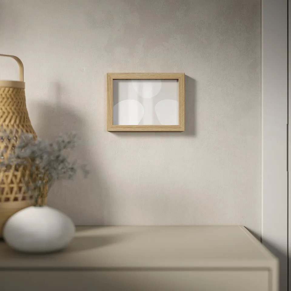 Minimalist wooden frame with abstract art, dried blue flowers, and woven basket.