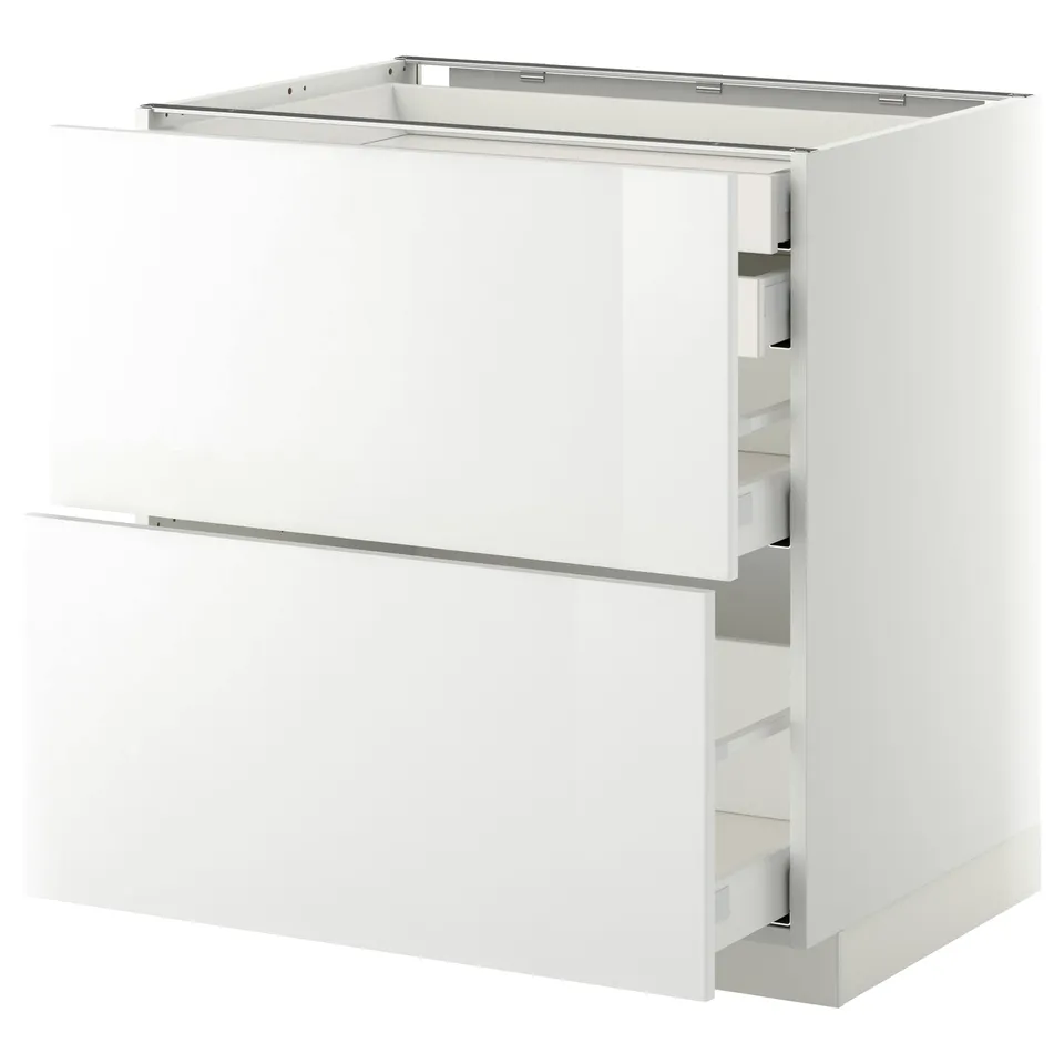 A METOD white kitchen cabinet with glossy white ringhult fronts, featuring multiple drawers.