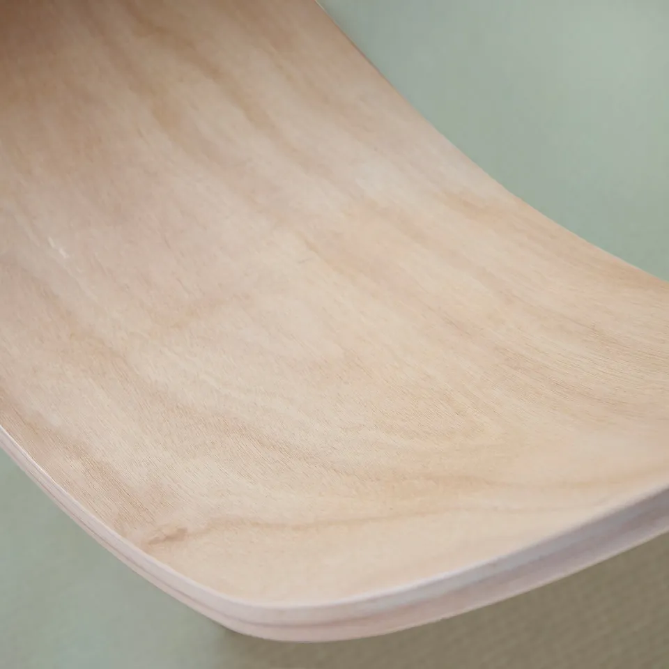 Sleek, curved wooden balance board showcasing smooth finish & quality craftsmanship.
