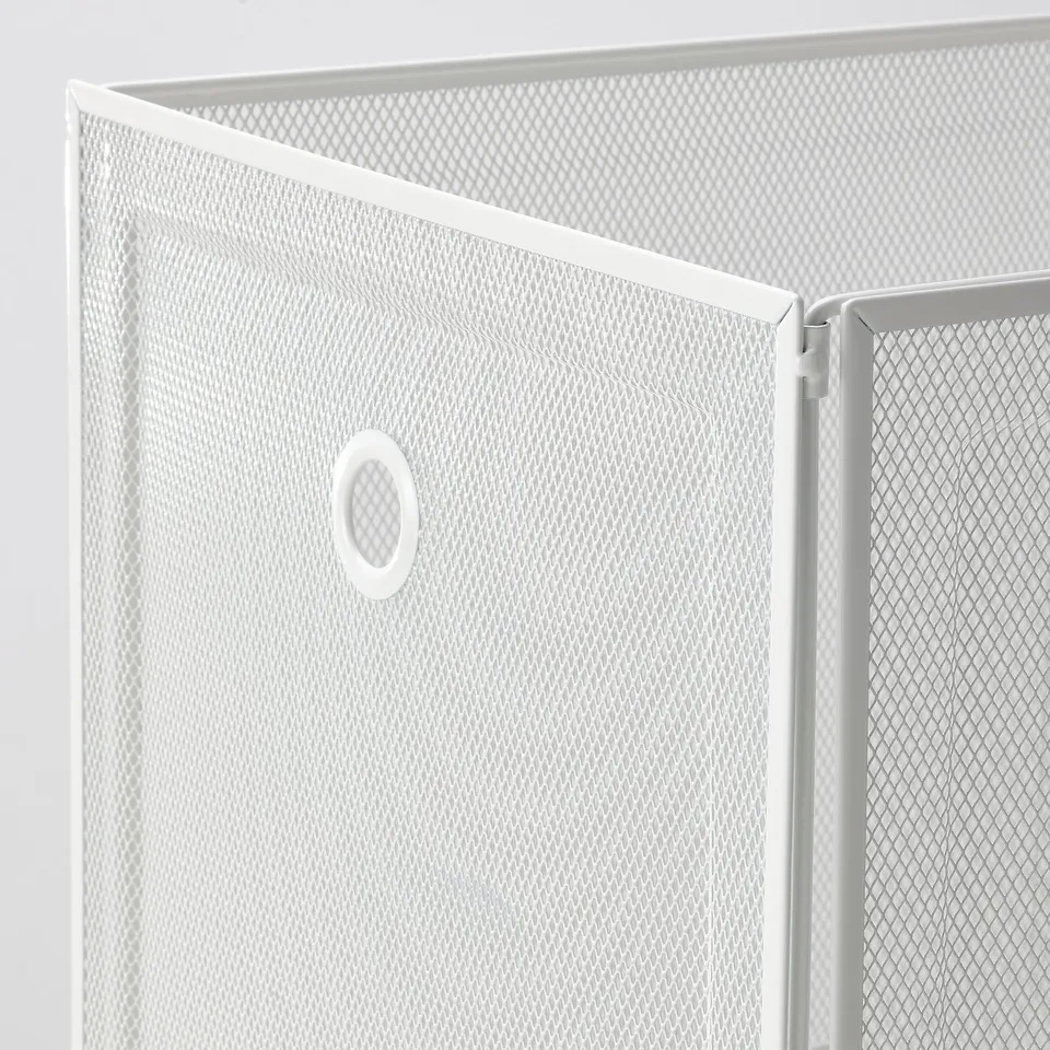 Close-up of white mesh storage box with robust metal frame and small circular handle.