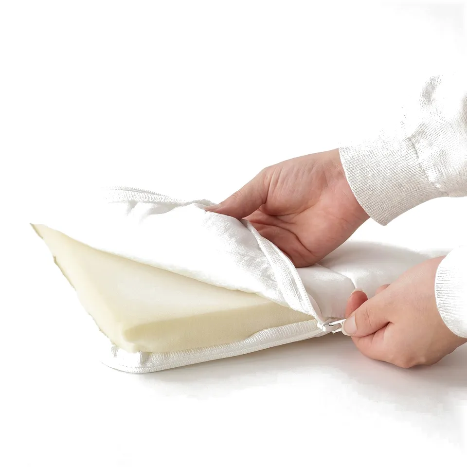 Person securing zip on mattress, ensuring easy cleaning and maintenance.