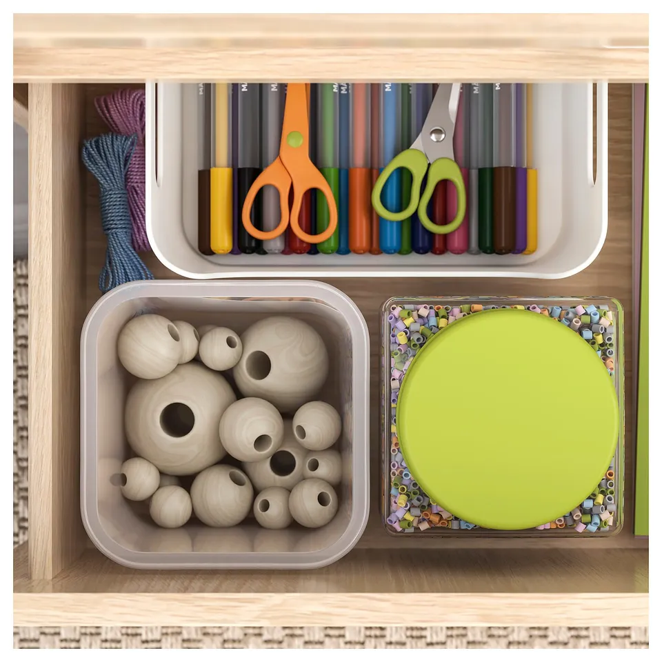 Organised craft drawer with beads, scissors, and markers in clear containers.