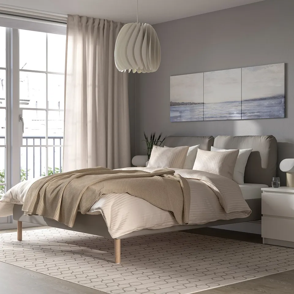 Modern cosy bedroom with SAGESUND bed, beige, purple walls, large window, art.