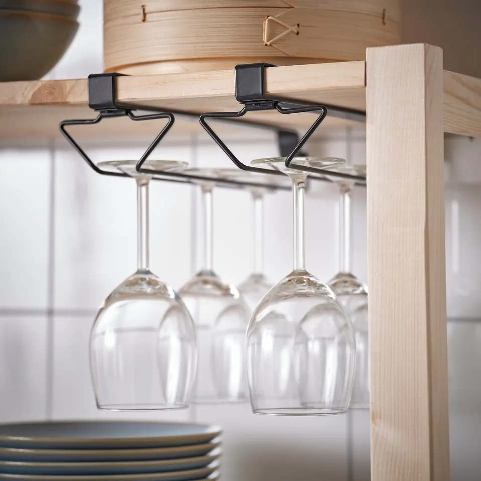 Wooden shelf with hanging wine glass holder, three empty wine glasses suspended.