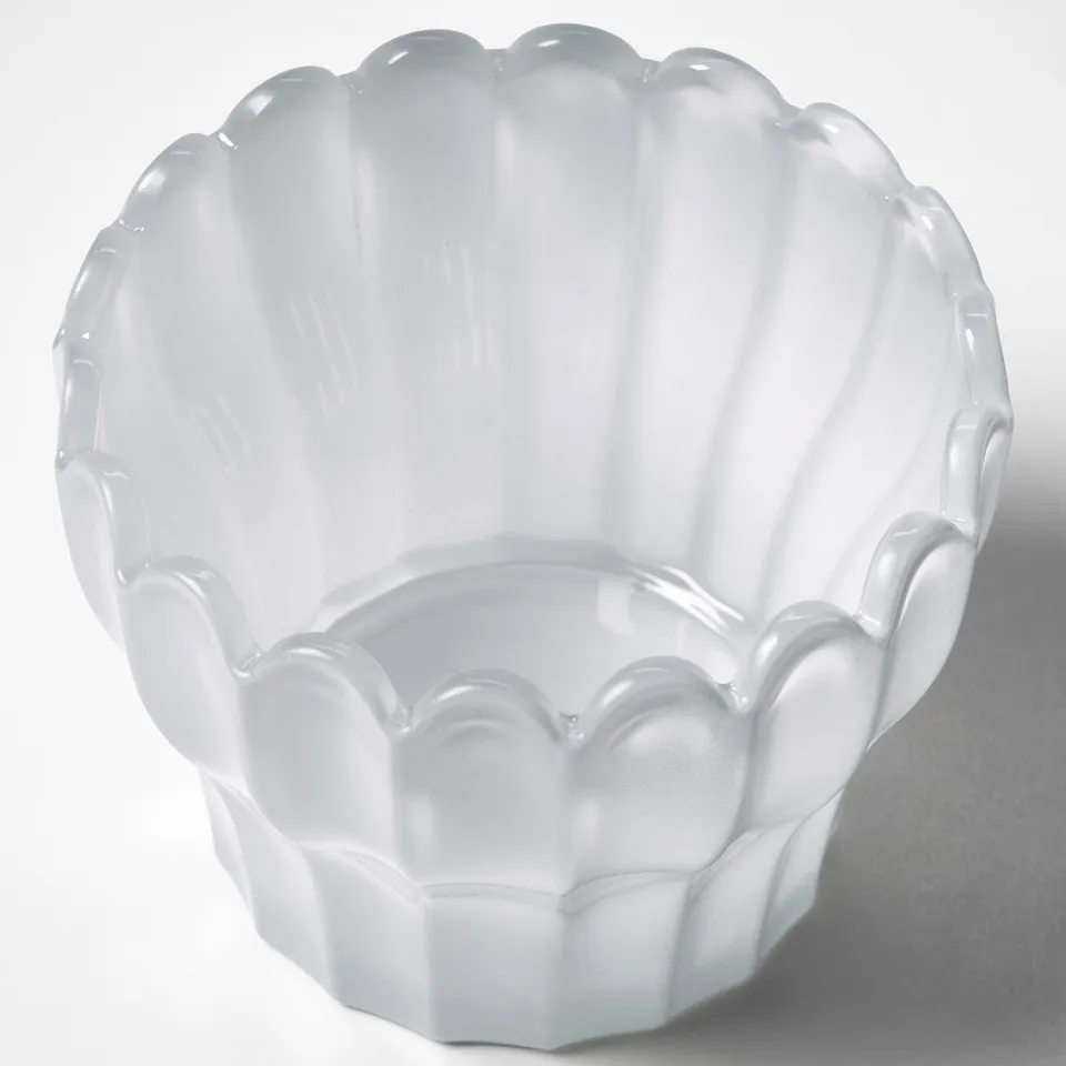 Elegant white glass bowl with scalloped edges. Crafted for quality, showcasing intricate petal design.