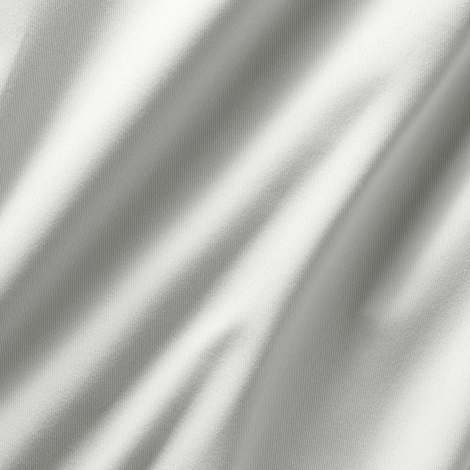 White curtains cascade softly, showing luxurious texture.