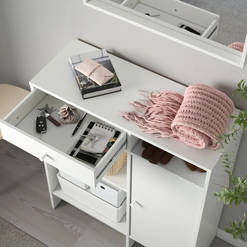 White dresser with drawers and shelves. Stores various items like keys, notebook, and blanket. Supports wall attachment for safety.