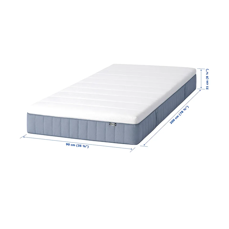 IKEA VALLBERGET mattress. White and grey, rectangular, firm with natural coir fibres, pocket springs, and foam. Size: 90x200 cm.