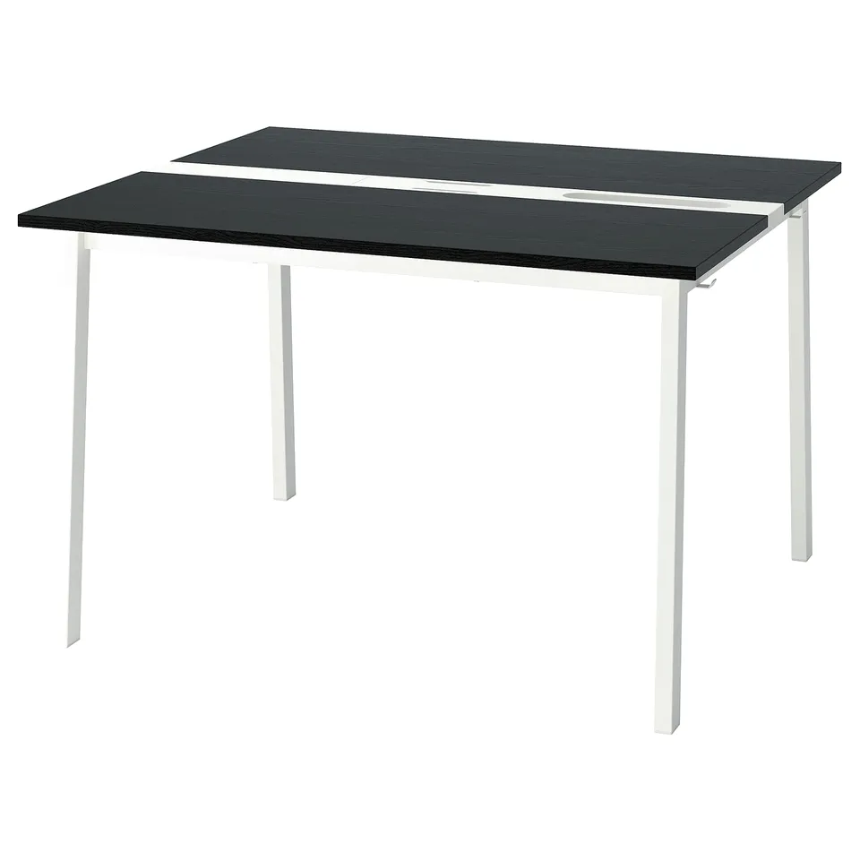 A black MITTZON conference table with white legs, rectangular shape, and smooth surface. Supports cable management.