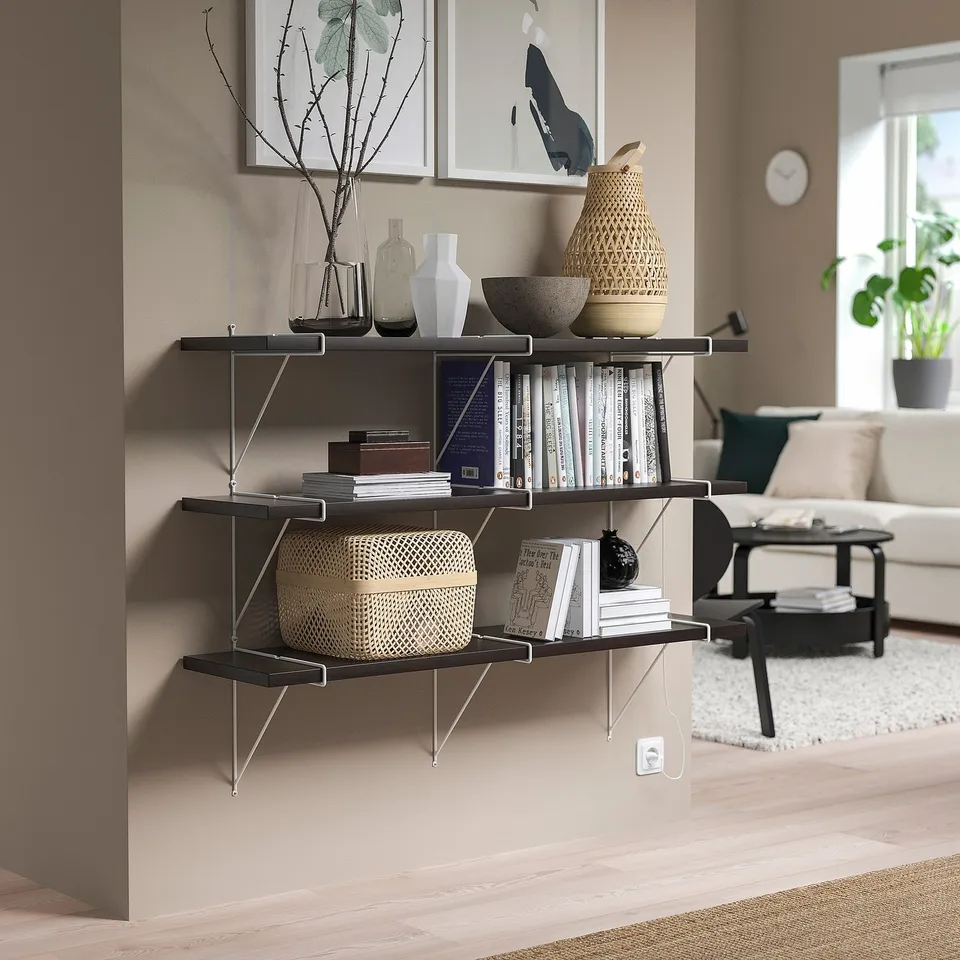 BERGSHULT black shelf with books, vases, bowls. Contrasts white, beige decor.