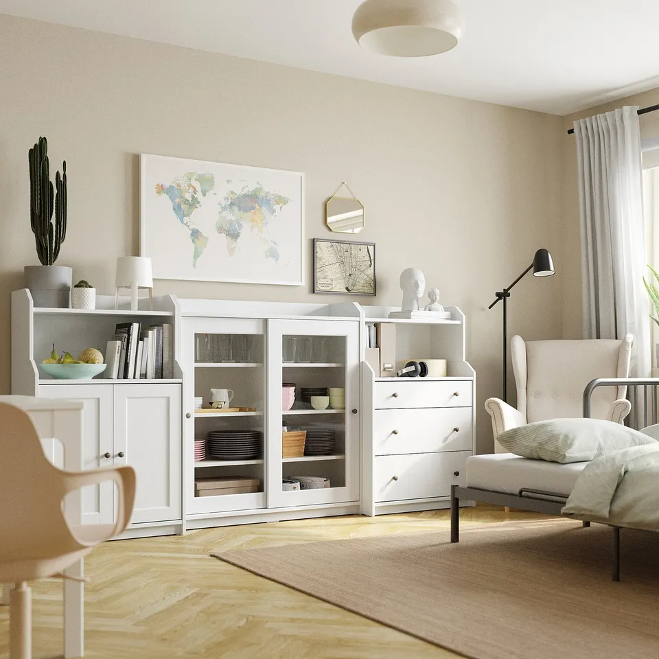 Modern living room with HAUGA storage, glass cabinet, chest, armchair, lamp.