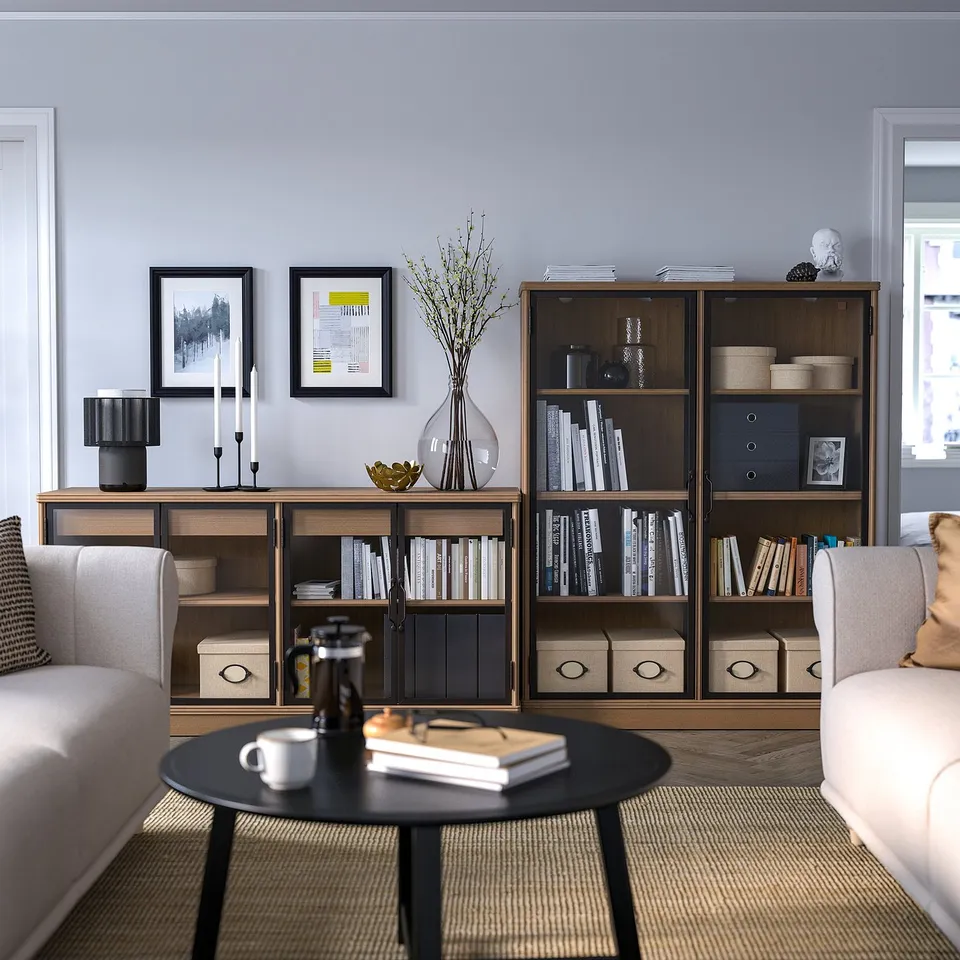 Cosy living room with bookshelf, sofas, and coffee table.