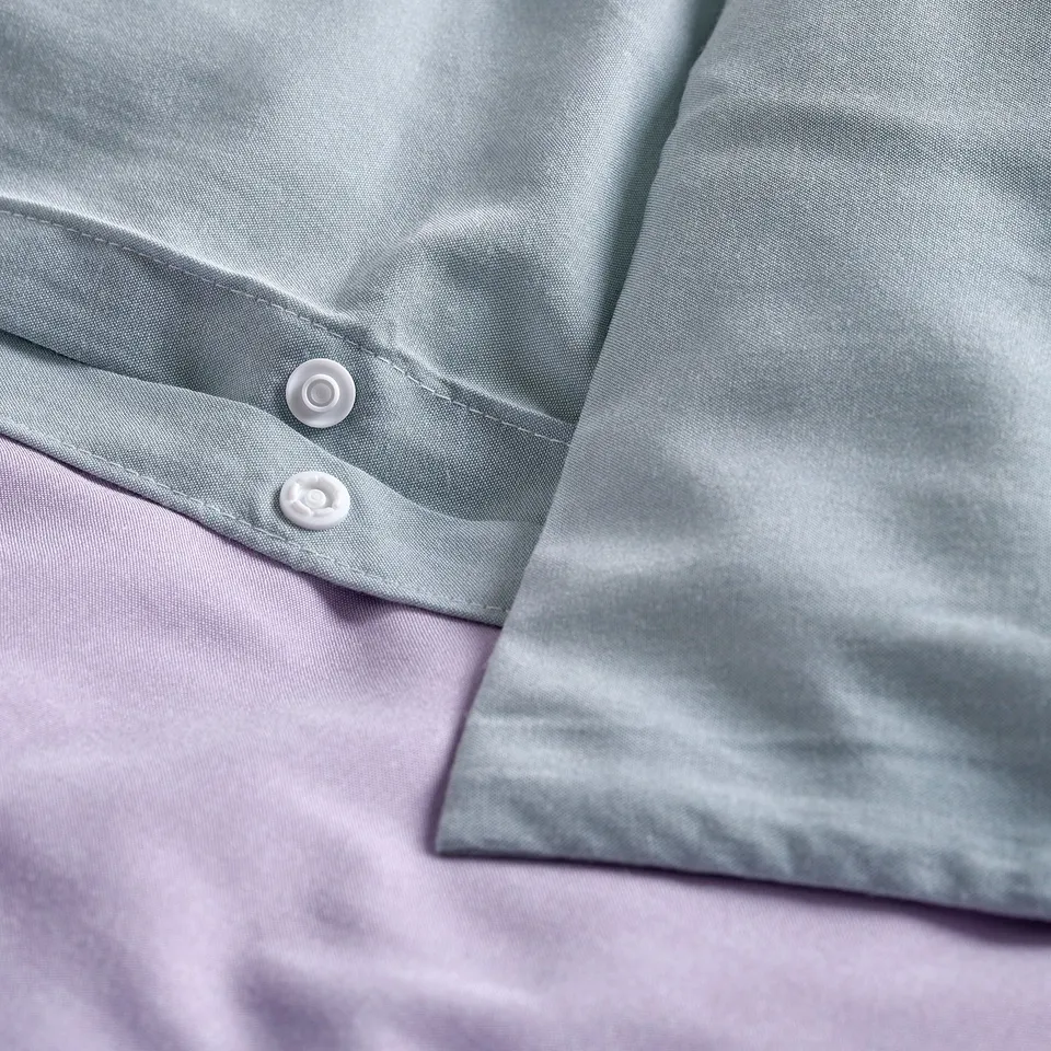Light grey duvet with button closure, showing smooth and wrinkle-free fabric.