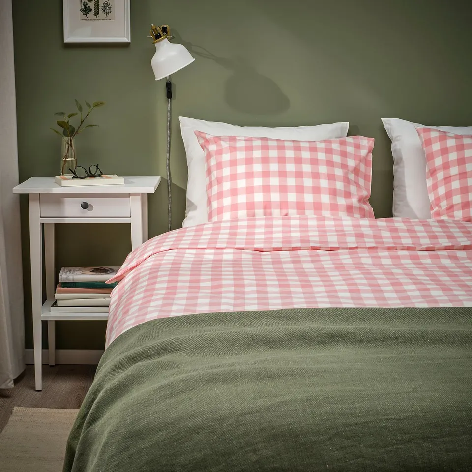 Twin beds with pink/white gingham duvets, nightstands, & green accents.