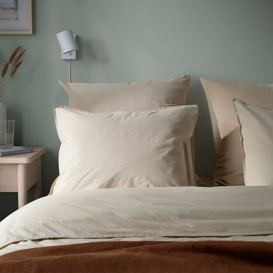 Beige velvet cushions on bed, one large for reading, with zip covers.