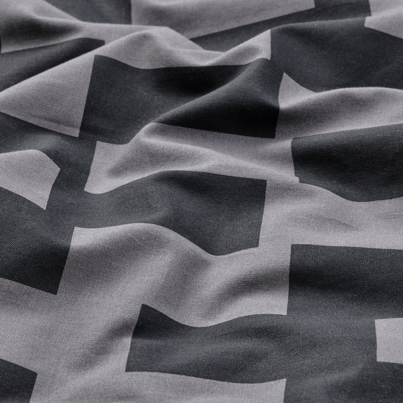 Abstract black-and-white geometric fabric design; smooth texture, intricate patterns.