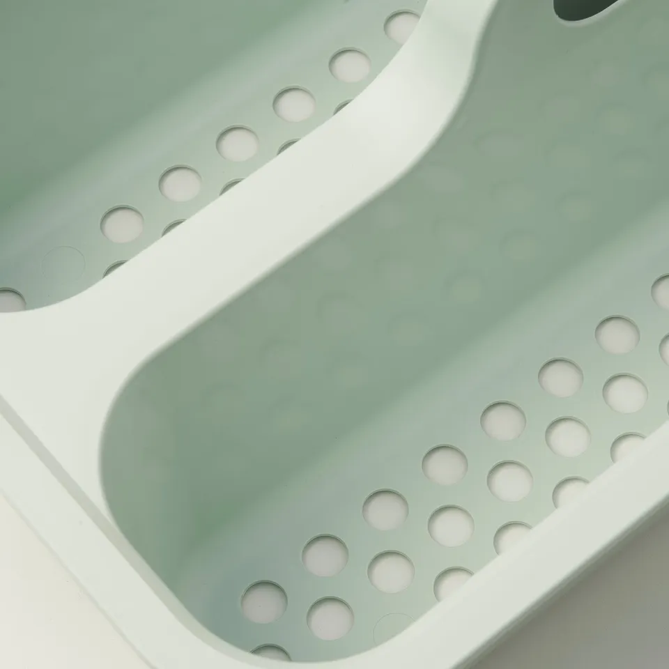 Wavy green PEPPRIG cleaning bucket in close-up, showcasing durable, textured design and circular drain holes.