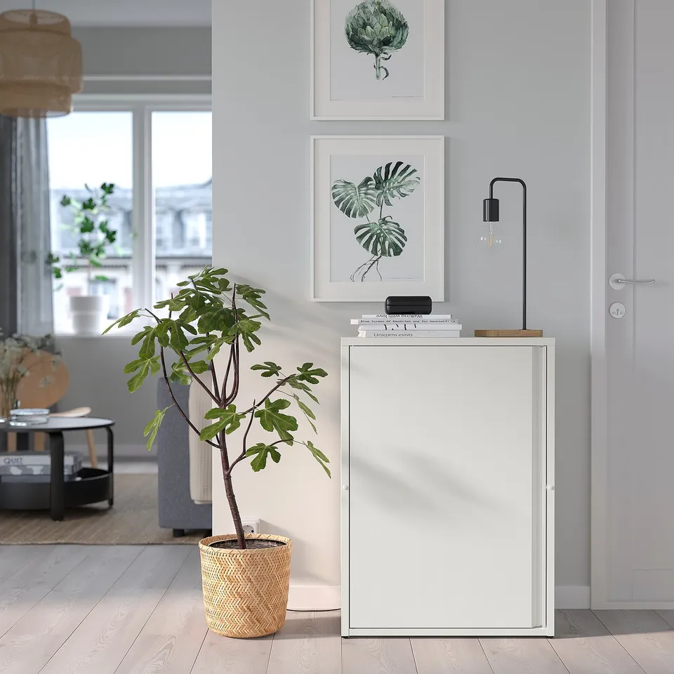 Modern white SUNDSÖ cabinet with adjustable feet and shelf, suitable for indoor/outdoor use; includes a potted plant.
