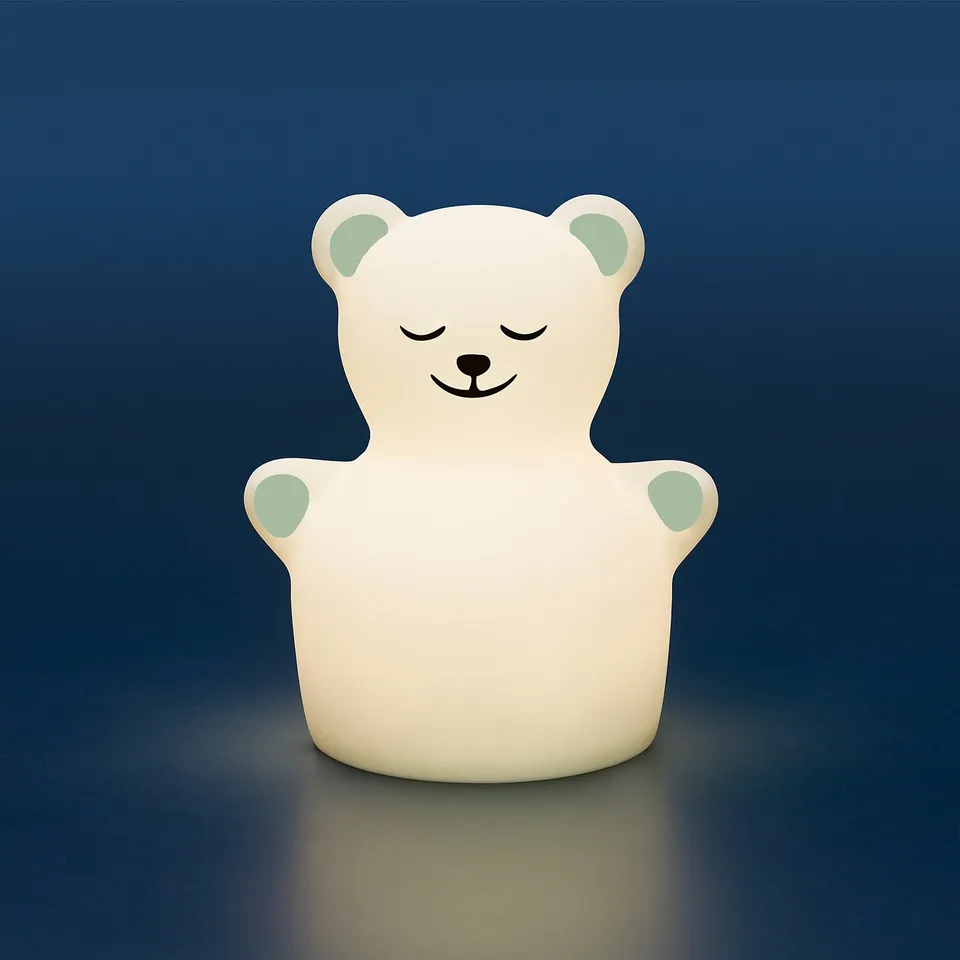 A glowing teddy bear night lamp for kids. It emits soft light in multiple colours.