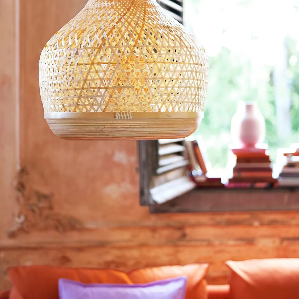 A hanging bamboo lamp, white, round, geometric pattern, soft glow, natural touch.
