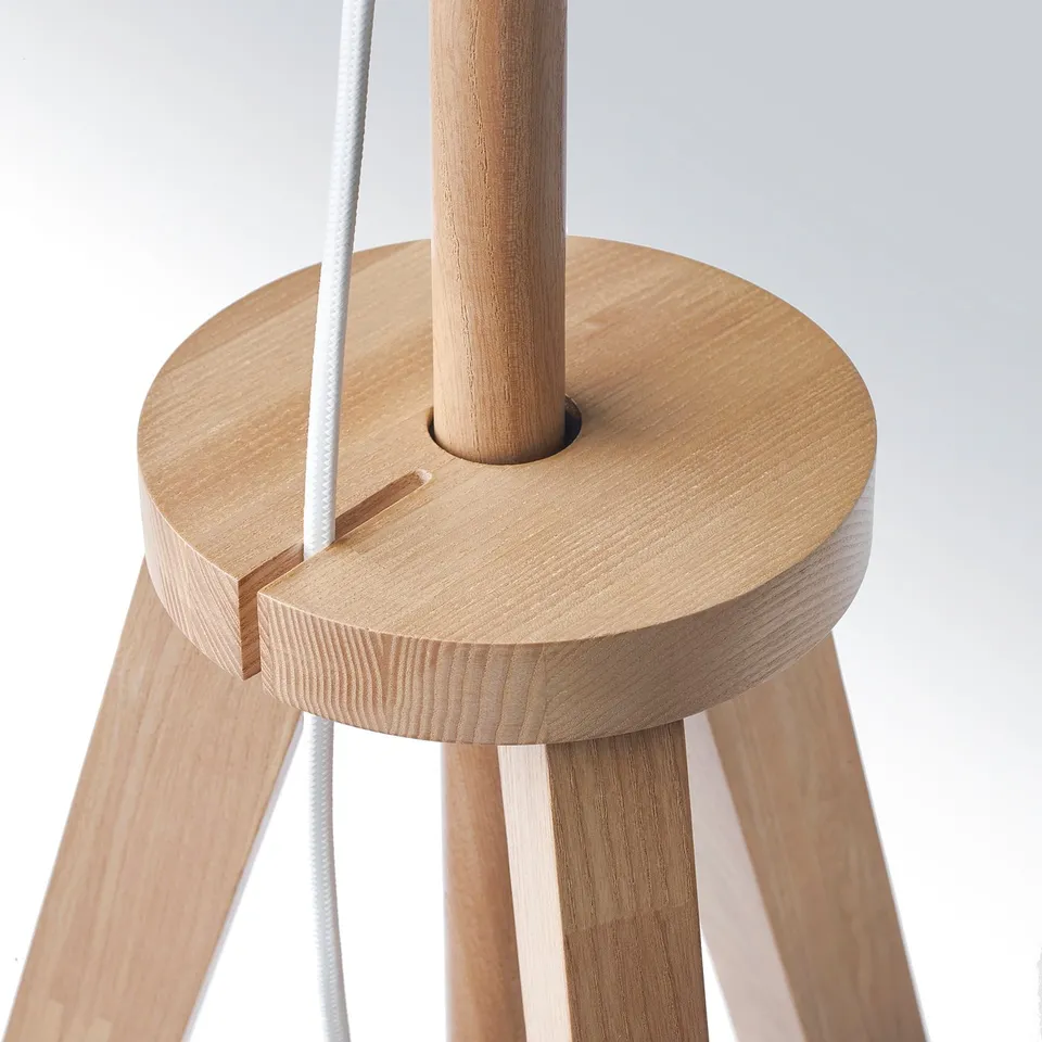 Wooden tripod lamp with white cord, showcasing high-quality craftsmanship.