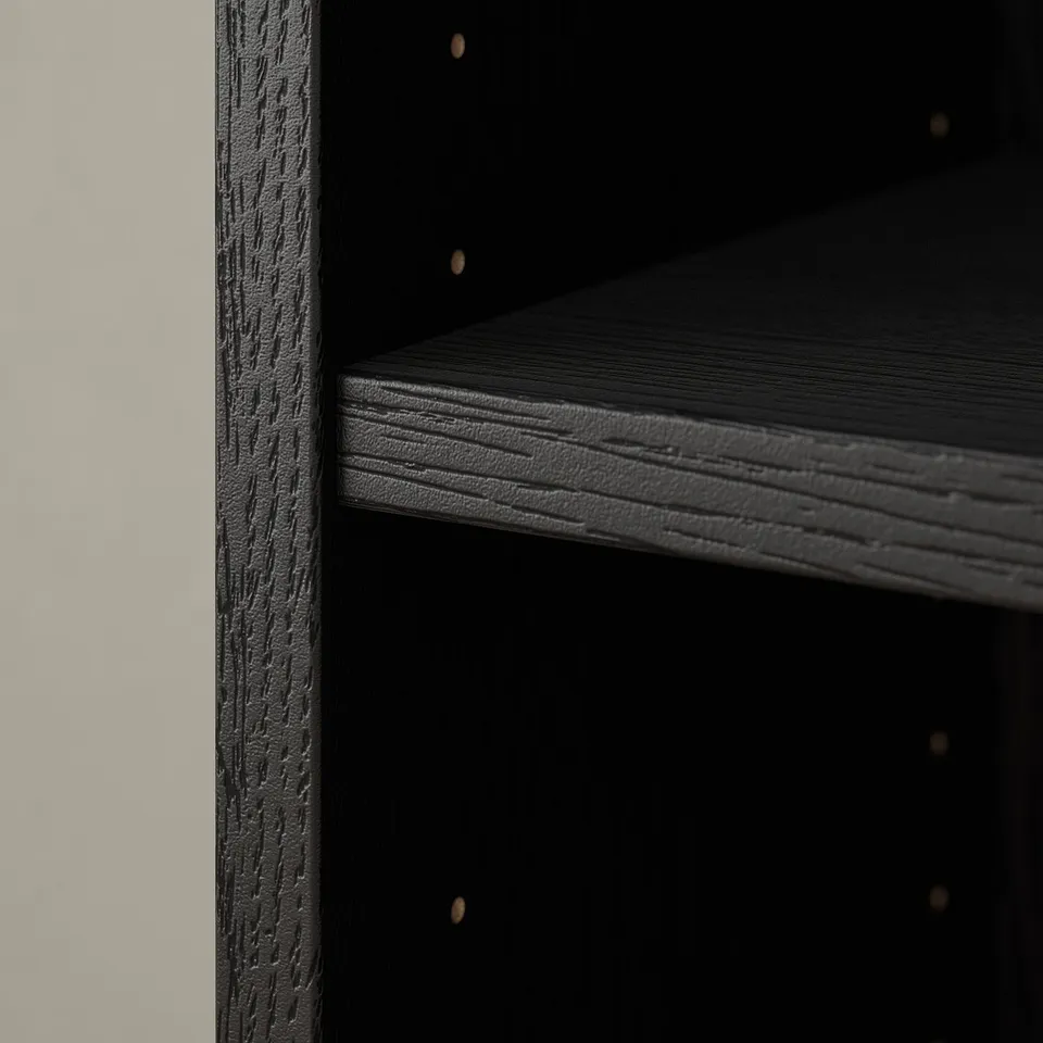 Dark wooden BILLY bookcase detail, showcasing textured finish and sturdy shelves.
