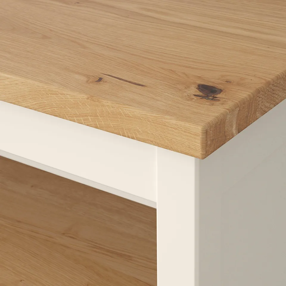 Close-up of a well-crafted wooden table with a smooth, natural finish and white legs, showcasing high-quality craftsmanship.
