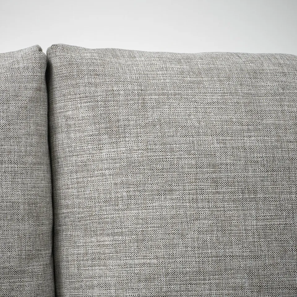 Close-up of modern, grey upholstered couch. Smooth, tight fabric, showing high quality.
