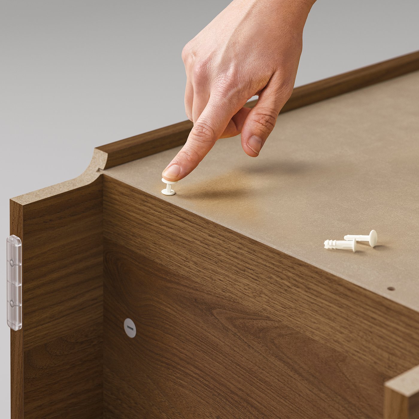 BILLY bookcase assembly: hand places pin in walnut-colored wooden drawer.