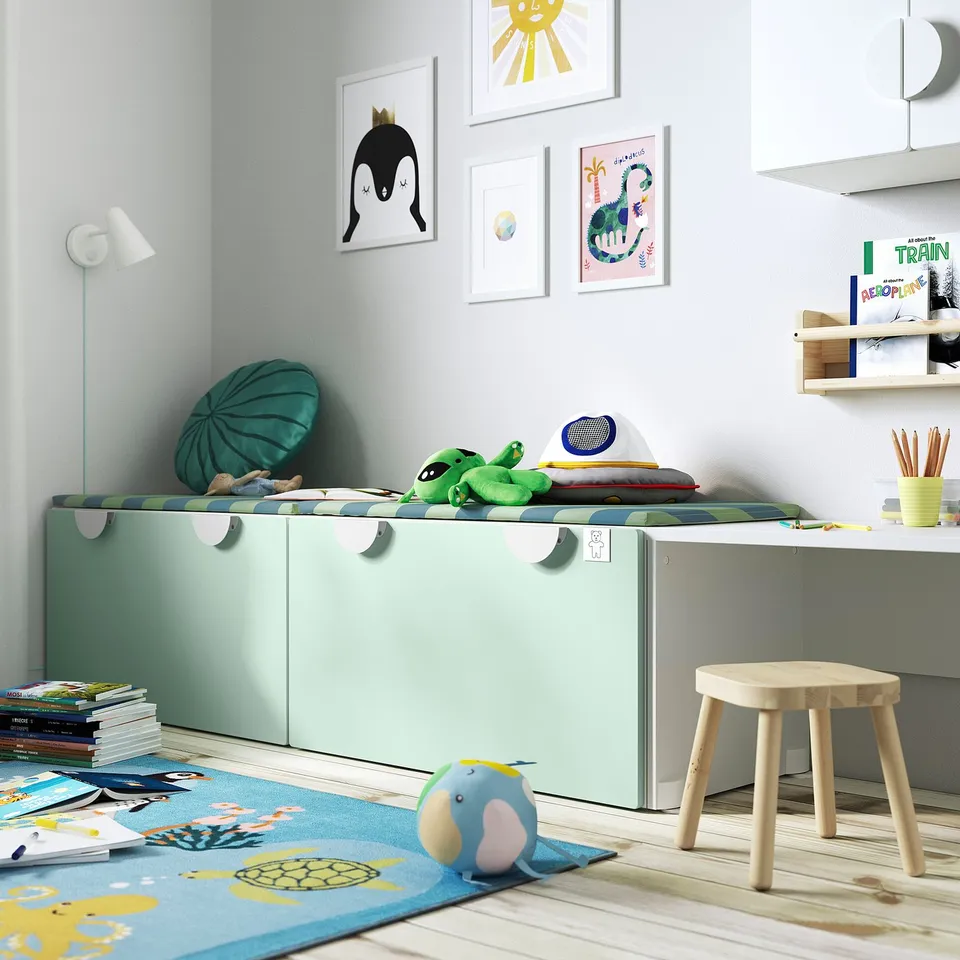 Childs room with SMÅSTAD light green storage. Toys, books, and art. Bright and organised.