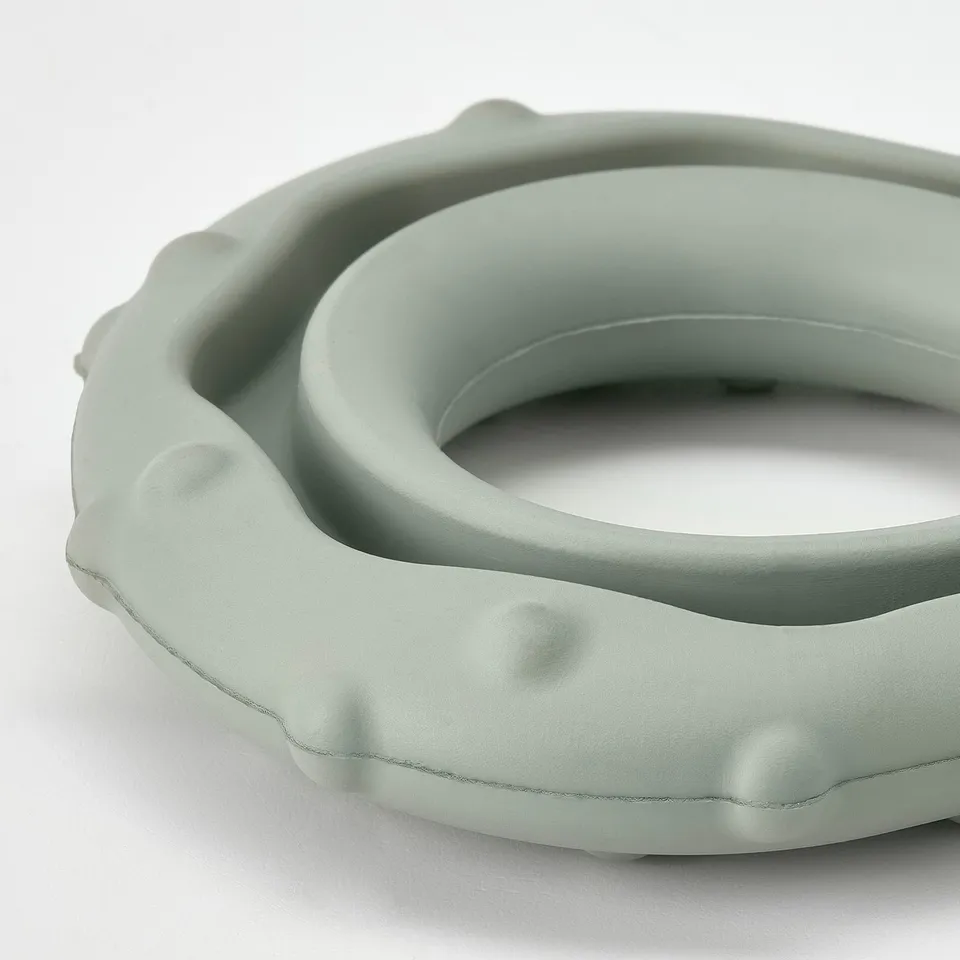 Round green dog toy with textured surface, made of natural rubber.