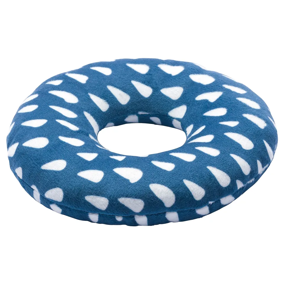 The UTSÅDD dog toy is a blue circular cushion with white irregular patterns, made from recycled polyester fabric and filling.