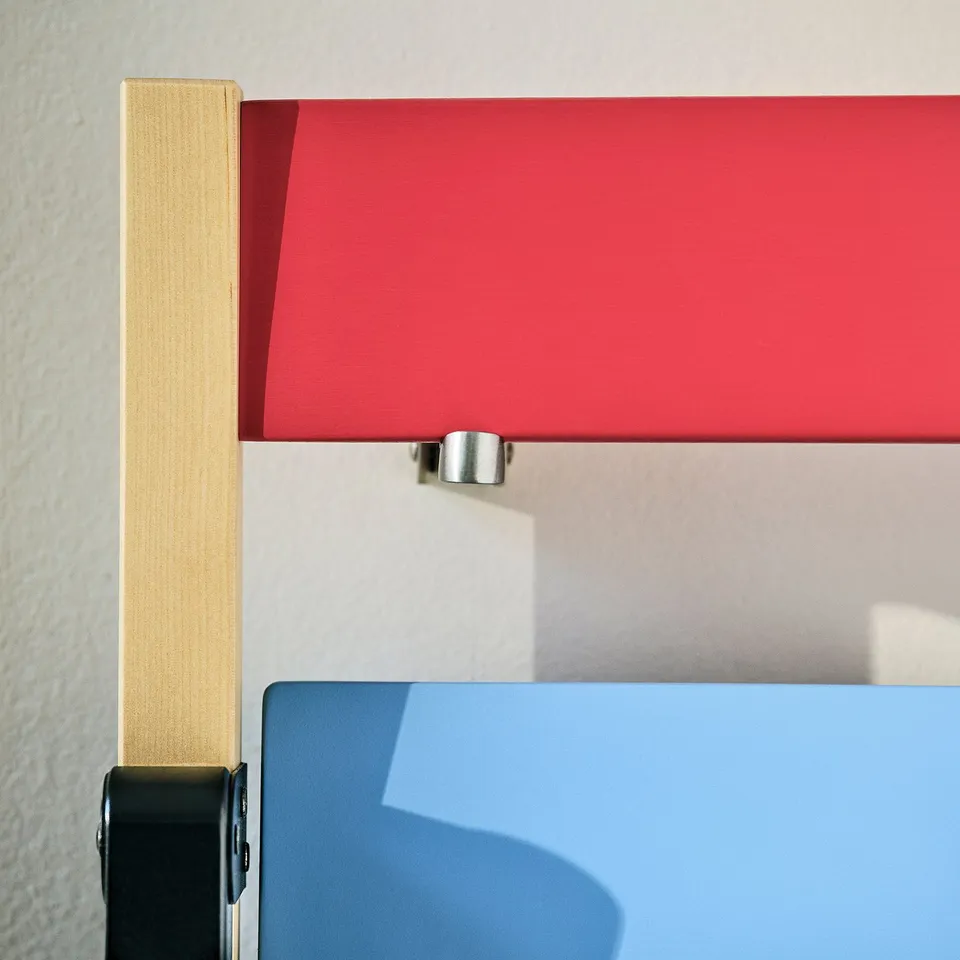 Vibrant red lamp with sleek metallic base; quality modern design.
