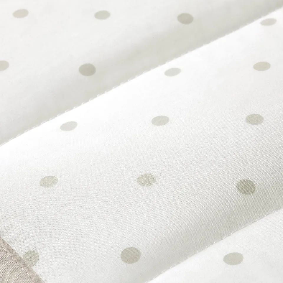 White cotton fabric with evenly spaced light grey dots, neatly folded, showing high quality and precision in stitching.
