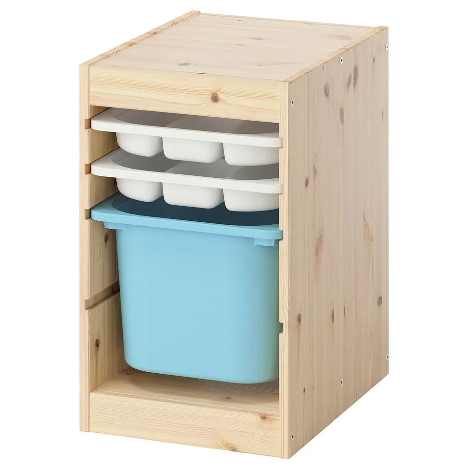 TROFAST light wood storage unit with blue bin and white trays. Modern kids storage with organised colours and materials.